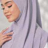 woman in light purple instant hijab with hand touching hijab